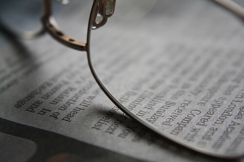 Glasses lenses resting on a book 